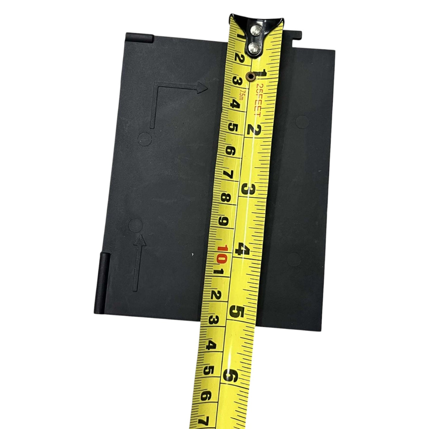 Black rectangular object with a yellow measuring tape on a white background