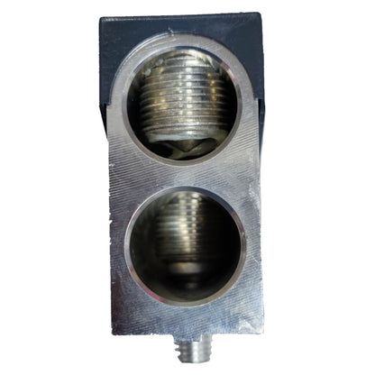 Metallic component with threaded holes on a white background