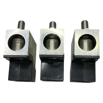 Three metal blocks with threaded holes on a white background