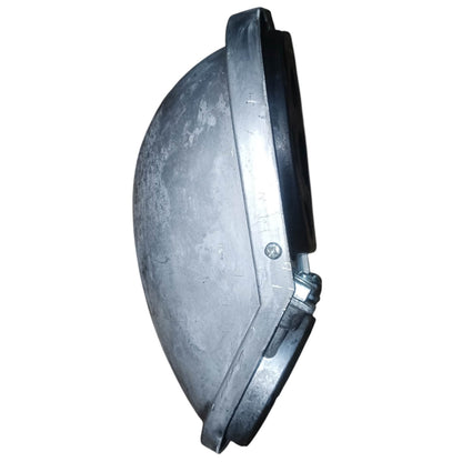 The underside of a circular black plastic device, likely a smart speaker or electronic control module, showing internal metal contacts, a barcode sticker, and a small pink tag on a white background.