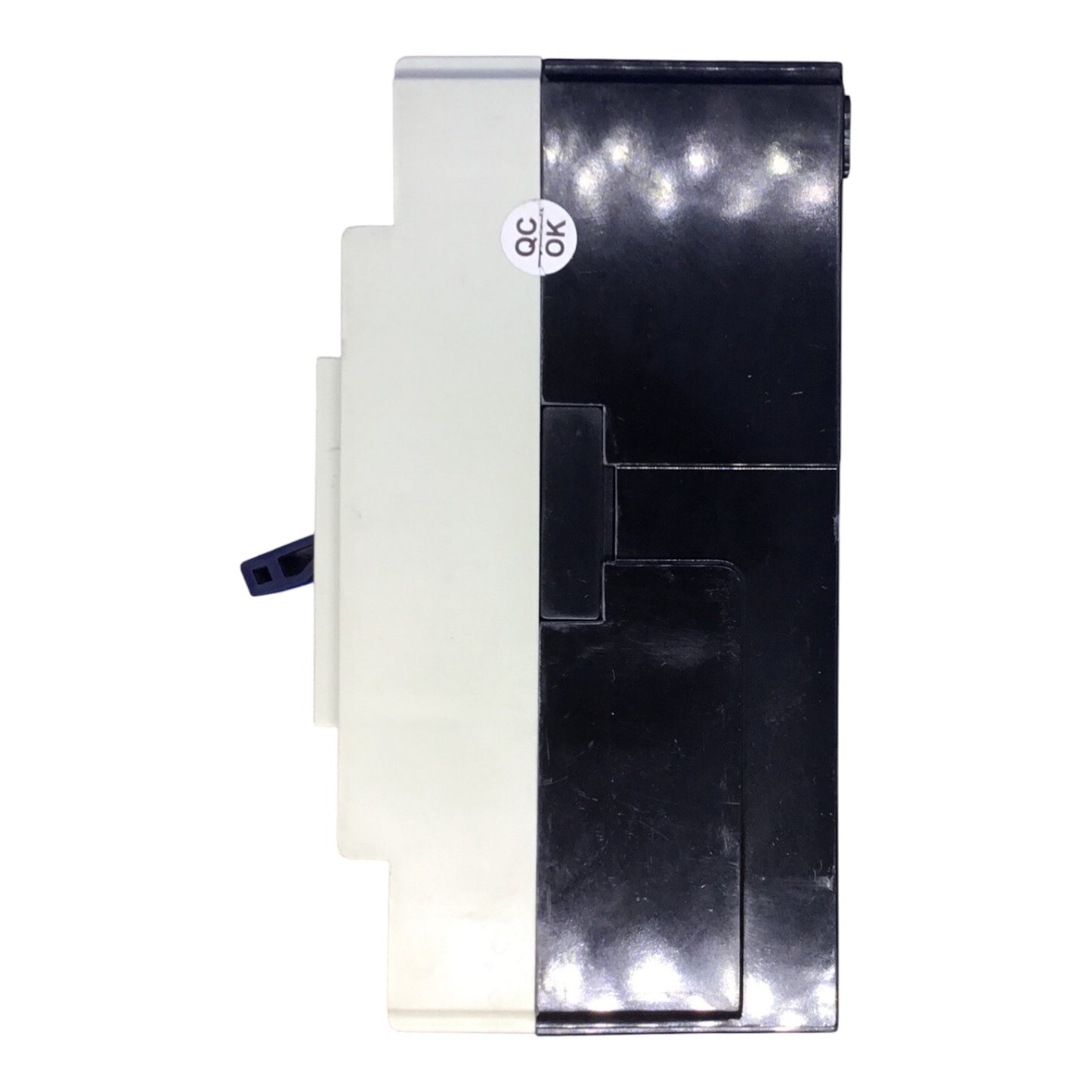 A replacement electronic component, likely a power supply or module, featuring a black plastic housing on the right and a white plastic housing on the left, with a small circular 'QC OK' sticker on the front.