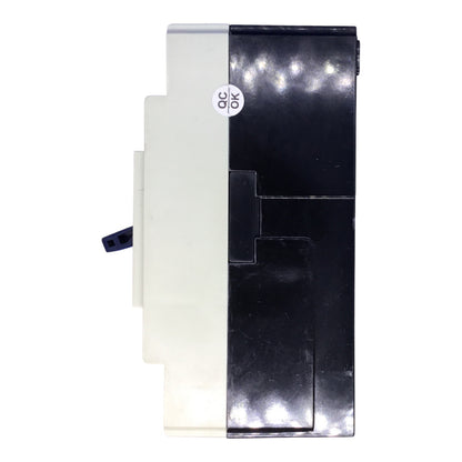 A replacement electronic component, likely a power supply or module, featuring a black plastic housing on the right and a white plastic housing on the left, with a small circular 'QC OK' sticker on the front.