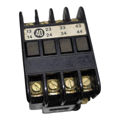 A black plastic electrical contactor terminal block with gold screw terminals and a white printed terminal numbering sticker, shown on a white background.