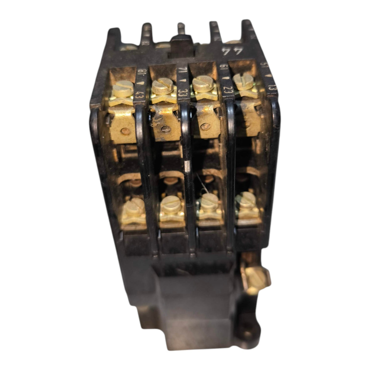 A black electrical contactor with gold-colored metal terminal blocks and screws, shown from a front-facing perspective on a white background.