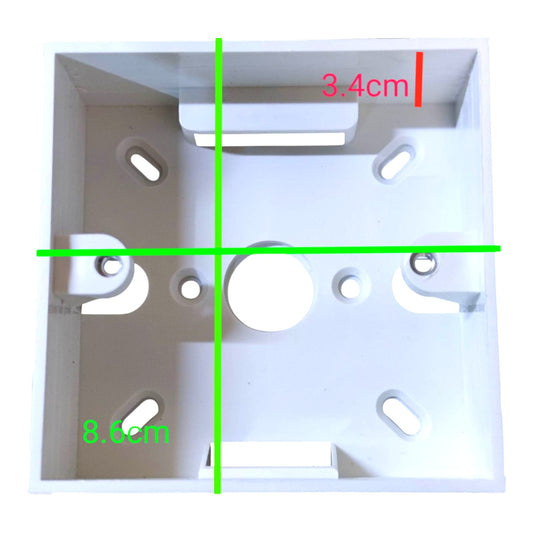 White plastic electrical junction box shown from above with green and red dimension lines indicating measurements of 8.6cm and 3.