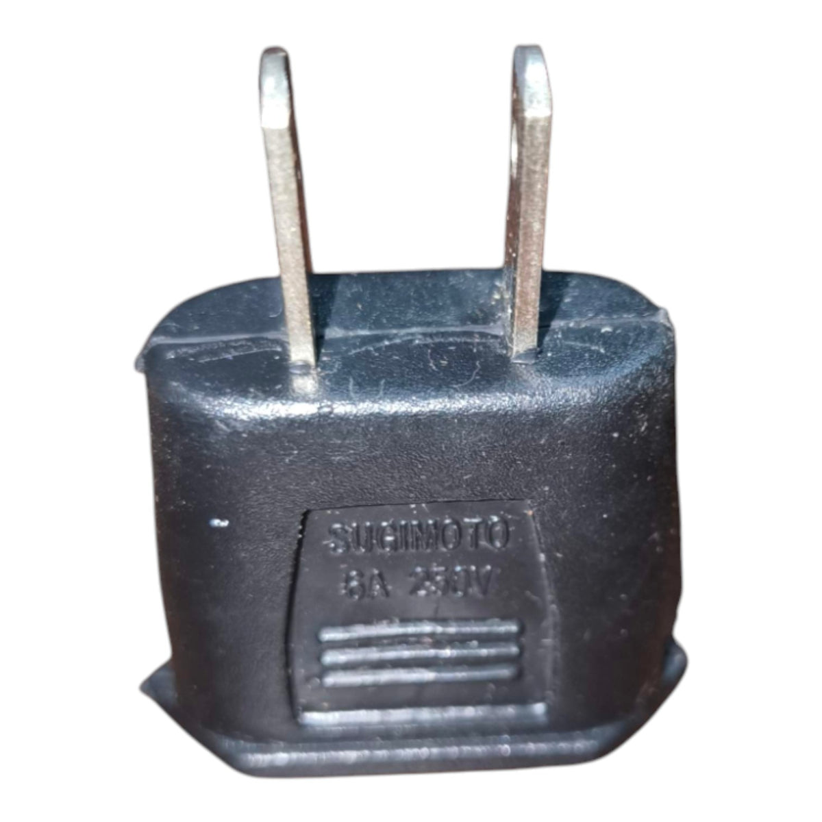 A black plastic motorcycle battery terminal adapter plug with two metal prongs, featuring an embossed label that reads 'SICHINO BA 230V'.