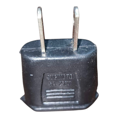 A black plastic motorcycle battery terminal adapter plug with two metal prongs, featuring an embossed label that reads 'SICHINO BA 230V'.