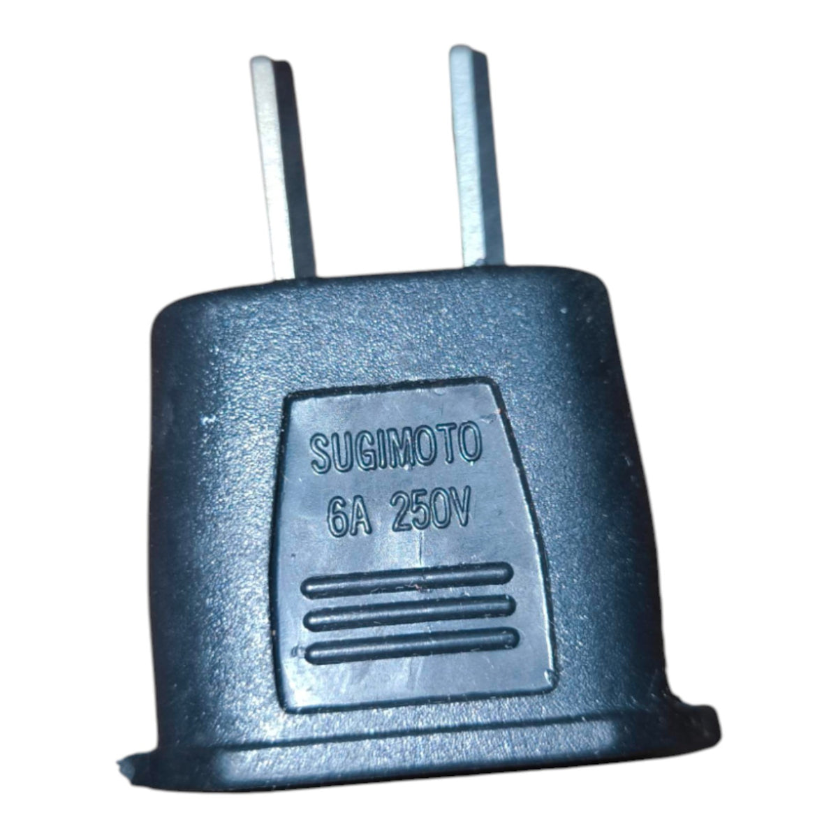 A black plastic Sugimoto 6A 250V two-pin plug adapter with silver metal pins, shown against a plain white background.