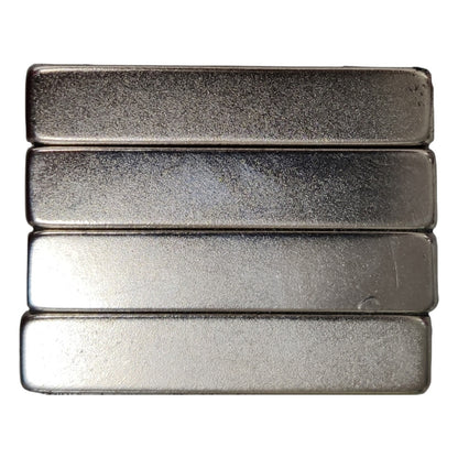 Four metallic bars of varying finishes on a white background