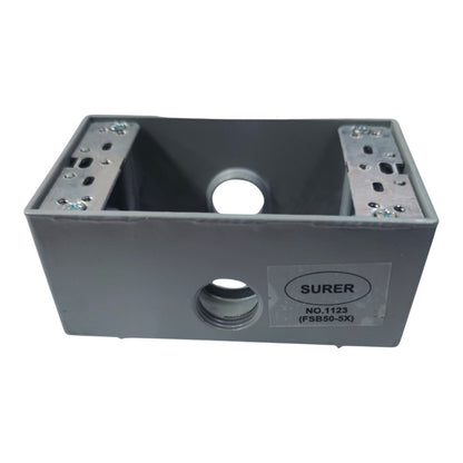 A gray metal electrical junction box with mounting slots on the top and a visible SURER brand label on the front, isolated on a white background.