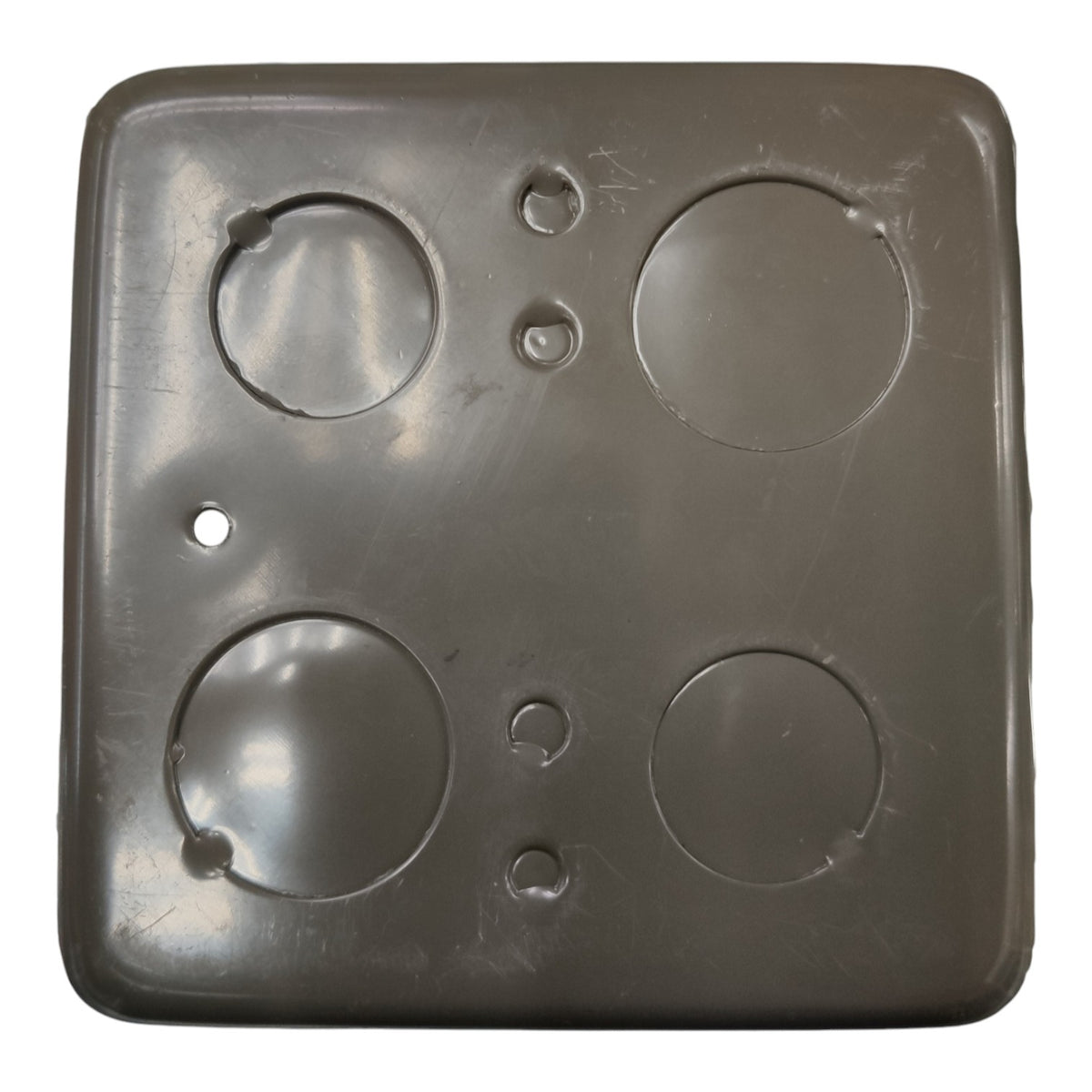 A square dark gray plastic cover with four circular cutouts and several small screw holes, shown against a plain white background.