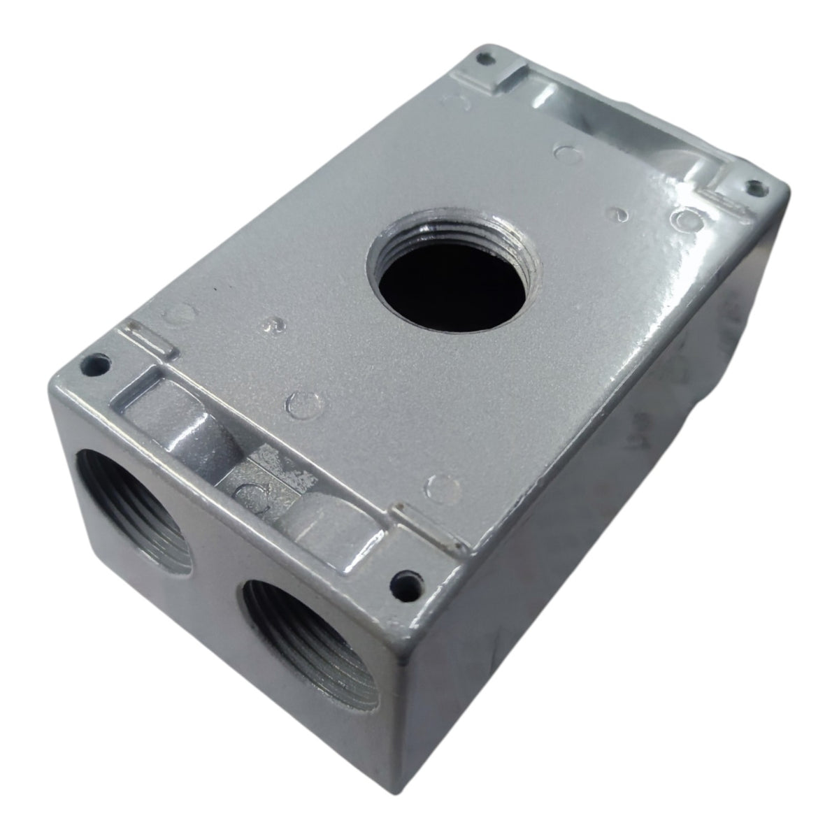 A silver cast metal plumbing fitting block with threaded ports and a central hole, shown on a plain white background.