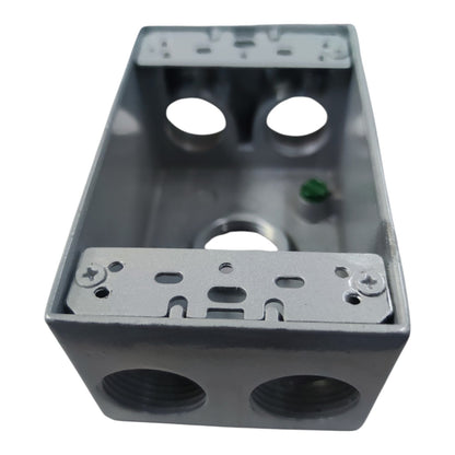 A gray metal electrical junction box with threaded conduit ports on the front and mounting slots on the top and bottom, shown on a plain white background.
