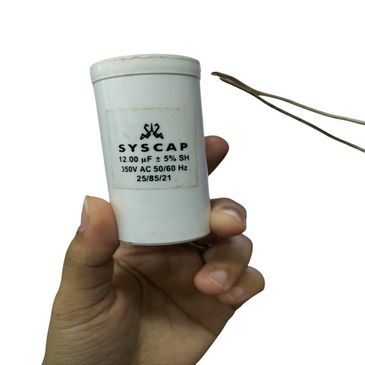 Syscap 12UF Motor Running Capacitor held in hand for electrical circuitry and motor applications