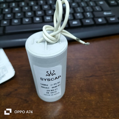 Syscap Motor Running Capacitor 14MFD 350V with white wires on wooden desk near keyboard