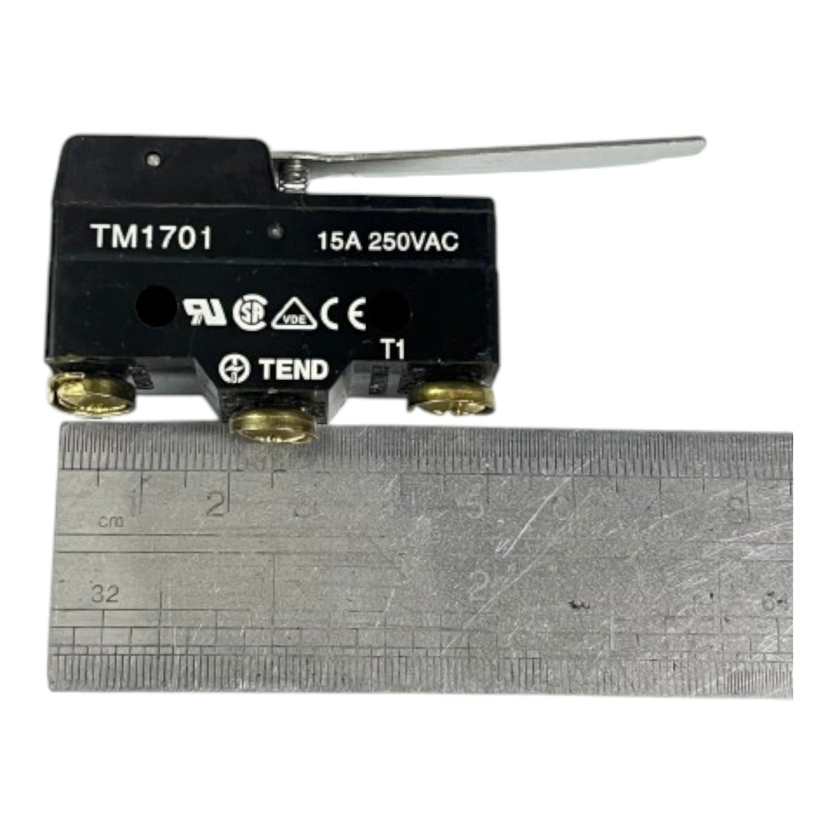 A black 15A 250VAC thermal relay switch with a silver lever and brass terminals, shown above a metal ruler for scale on a white background.