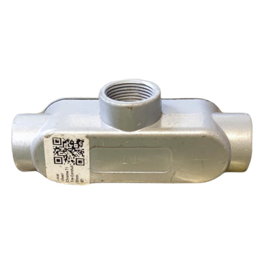Metal pipe fitting with a QR code label on a white background