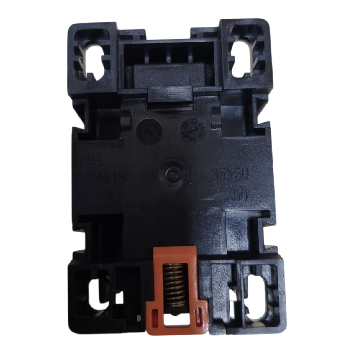 A black plastic electrical contactor or relay component with a prominent orange terminal cover and internal spring, shown against a plain white background.