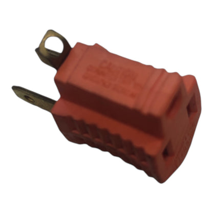 A red plastic electrical outlet plug with metal terminals, isolated on a white background.