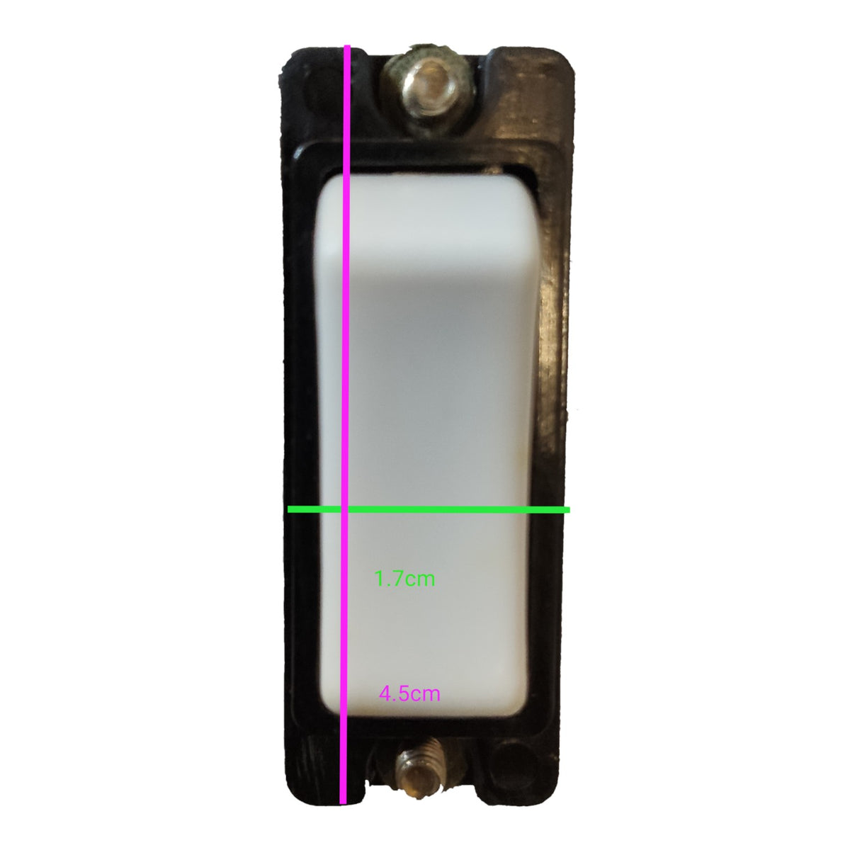 A rectangular black plastic electrical switch or socket component on a white background, overlaid with green and pink measurement lines and text indicating dimensions 1.7cm and 4.
