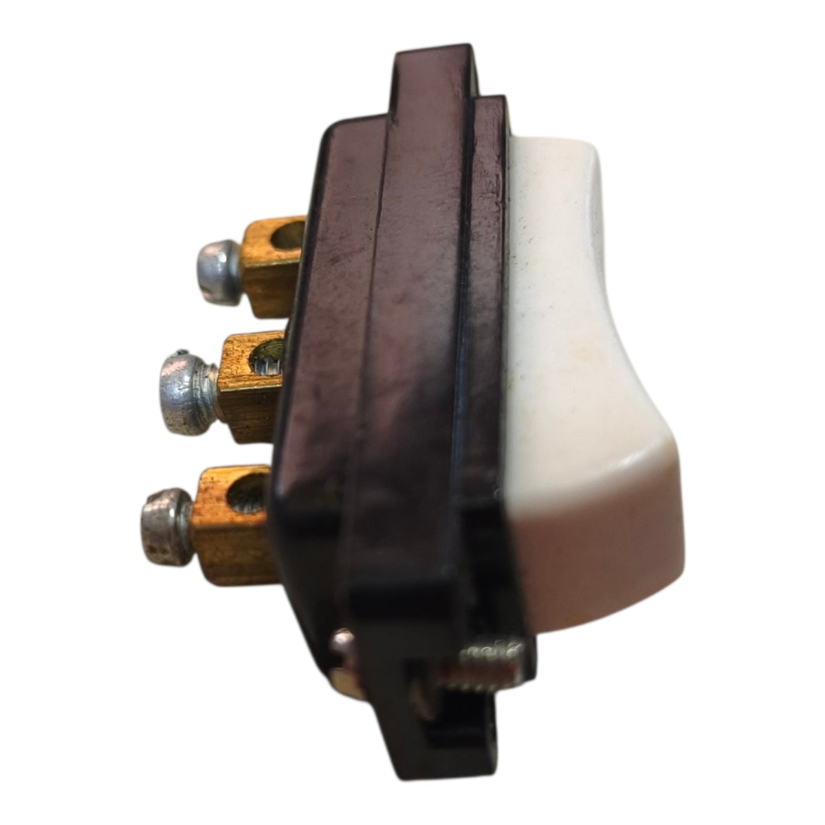 A single-pole toggle switch with a black plastic housing, a white plastic lever, and brass screw terminals, shown on a plain white background.