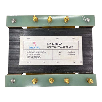 A industrial BK-5000VA control transformer with a black core, green metal end plates, and gold screw terminals, featuring a white specification label.