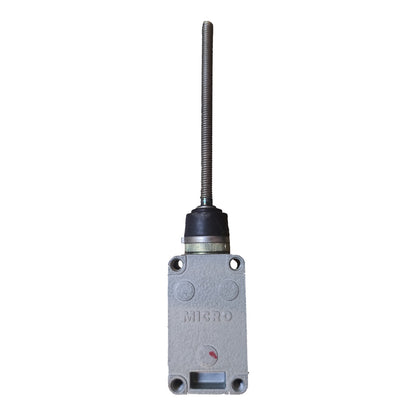 A gray cast metal industrial control valve with a long threaded metal rod extending upwards, featuring a black rubber grommet and a small red indicator mark on the front face.