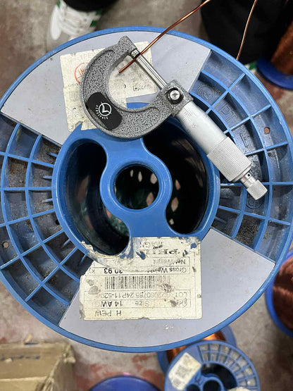 Philflex AWG 14 magnet wire on a spool with a micrometer measuring its thickness