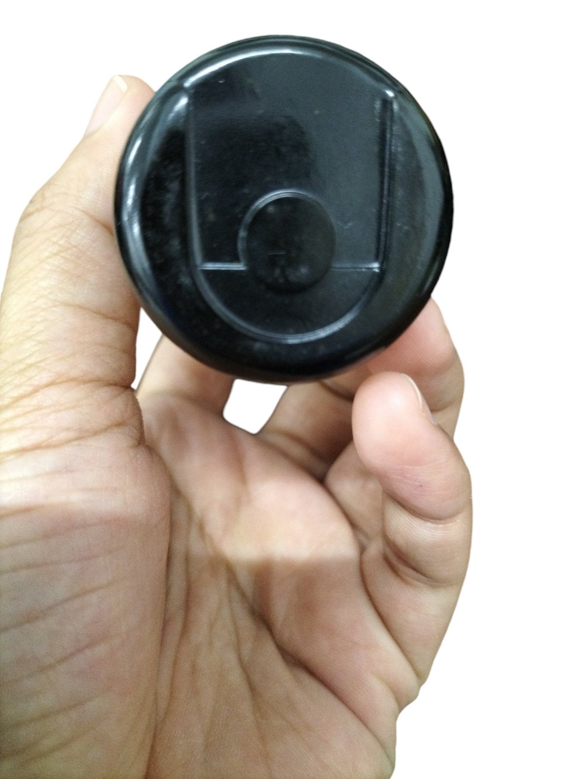 BC 243-292MFD Motor Starting Capacitor held in hand, featuring a black rounded design