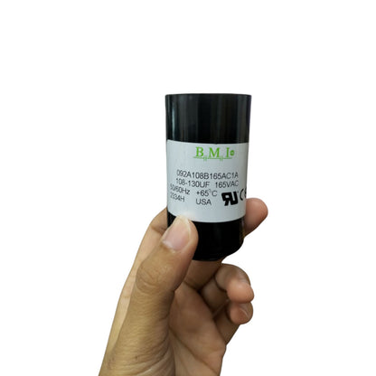 BMI 108-130mfd capacitor 165v held in hand showcasing its black cylindrical design and label details