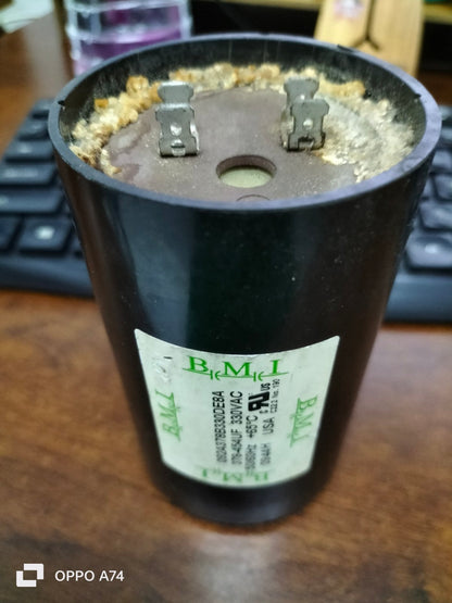 BMI 378-454UF starting capacitor electrical component with dual terminals on wood surface