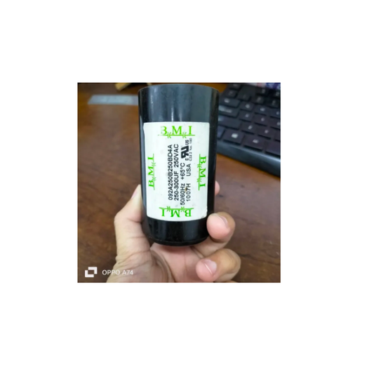 BMI black motor starting capacitor 250-300 uf held in hand with visible product label and specifications