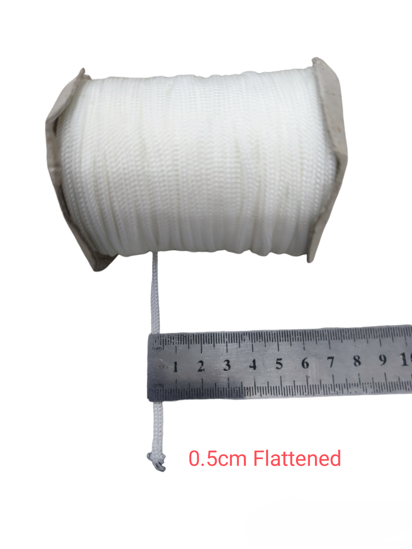 White cloth rope spool measured with a ruler showing 0.5cm flattened width Cloth Rope - Per Meter