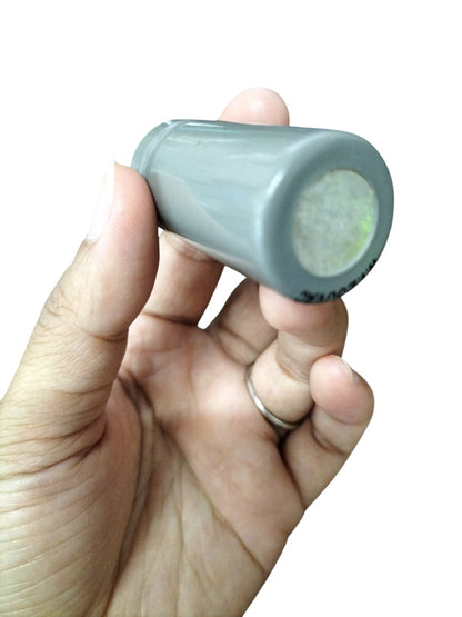 Hand holding a gray 0.5MFD Motor Running Capacitor from DRE for electrical circuitry and parts