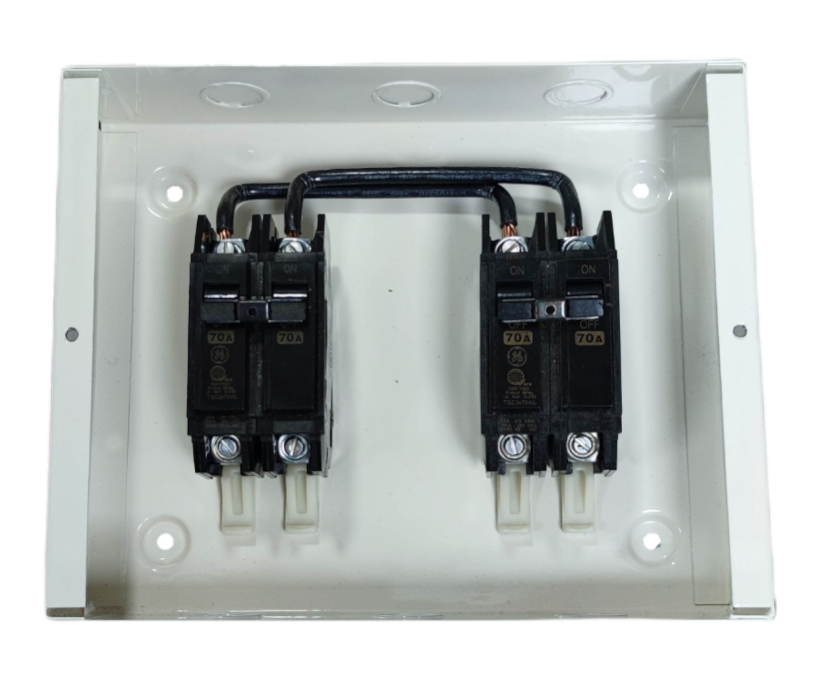 GE Koten electrical switchgear with black circuit breakers mounted inside white metal enclosure