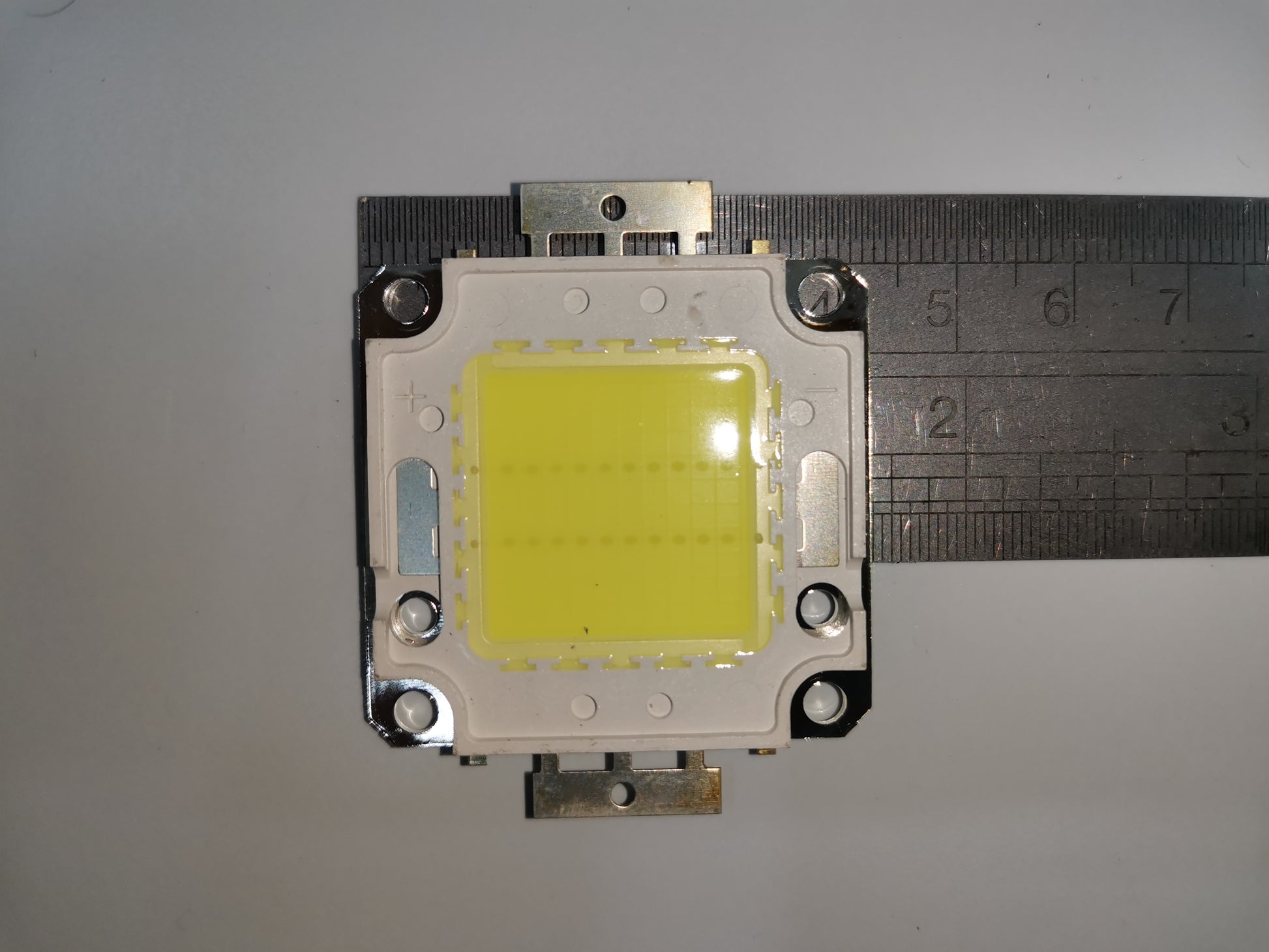 20w high power LED chip close-up with metal housing and ruler for size measurement