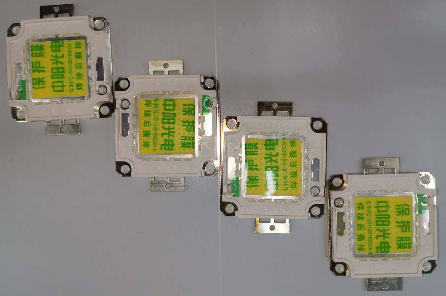 China made 20w high power LED chip modules arranged in a row on a gray surface