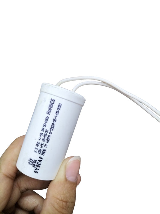 Syscap 250 VAC 3.5MFD Running Capacitor held in hand with white casing and wires