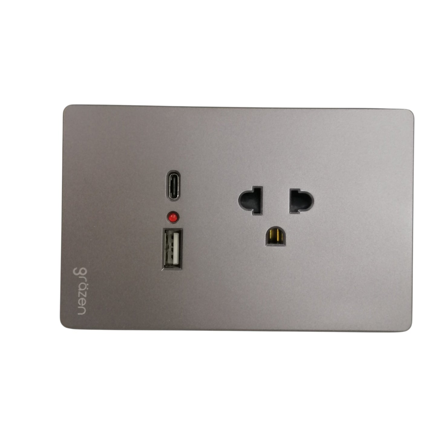 A square wall power adapter or charging dock with a brushed silver metal faceplate, featuring a USB-C port, a USB-A port, a small red indicator light, and a US-style outlet on a white background.