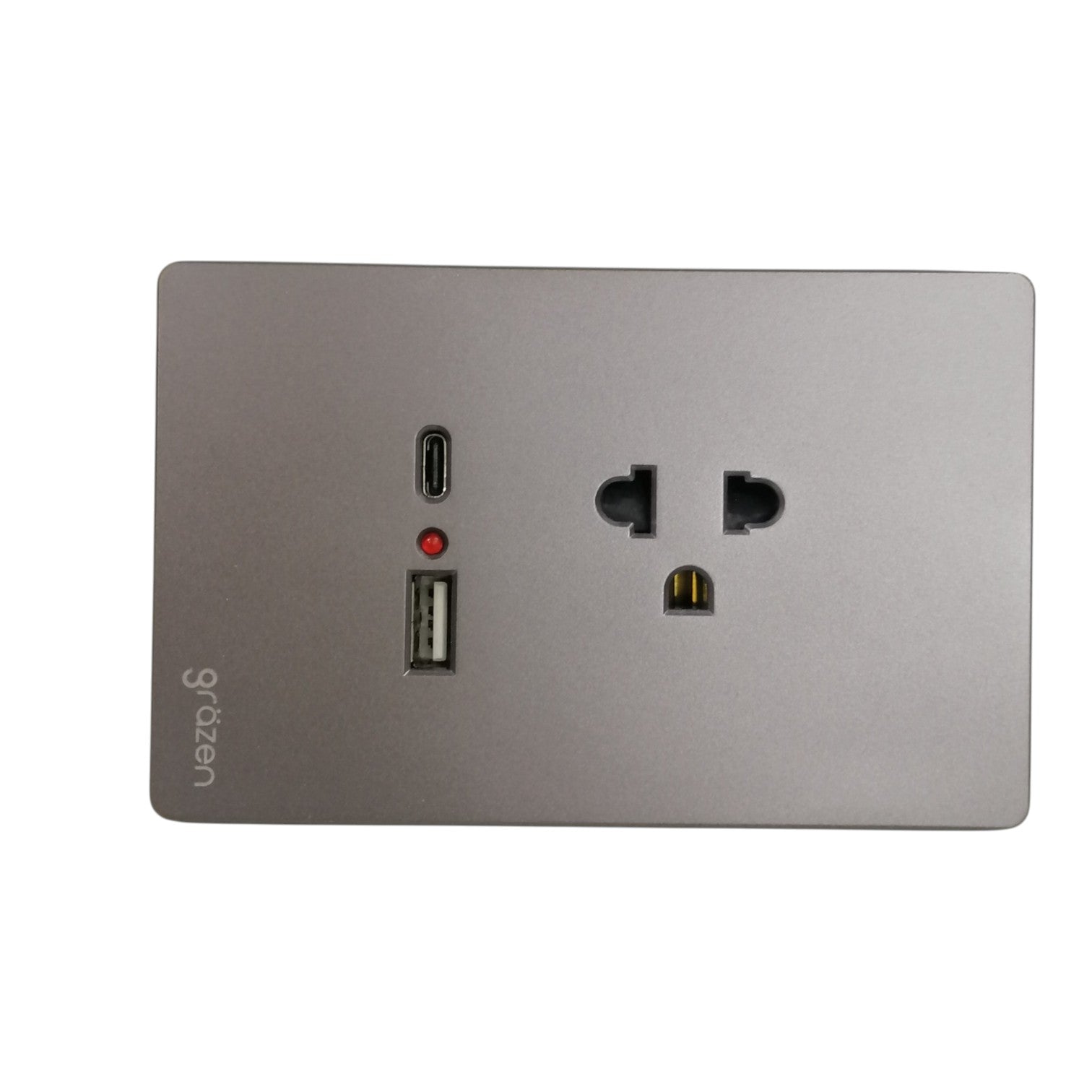 A square wall power adapter or charging dock with a brushed silver metal faceplate, featuring a USB-C port, a USB-A port, a small red indicator light, and a US-style outlet on a white background.