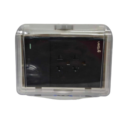 A black dual electrical outlet covered by a clear, transparent protective plastic case, shown against a plain white background.