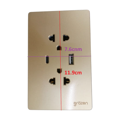A gold wall-mounted dual USB-A and US outlet power strip with dimension markings showing 7.6cm, 11.