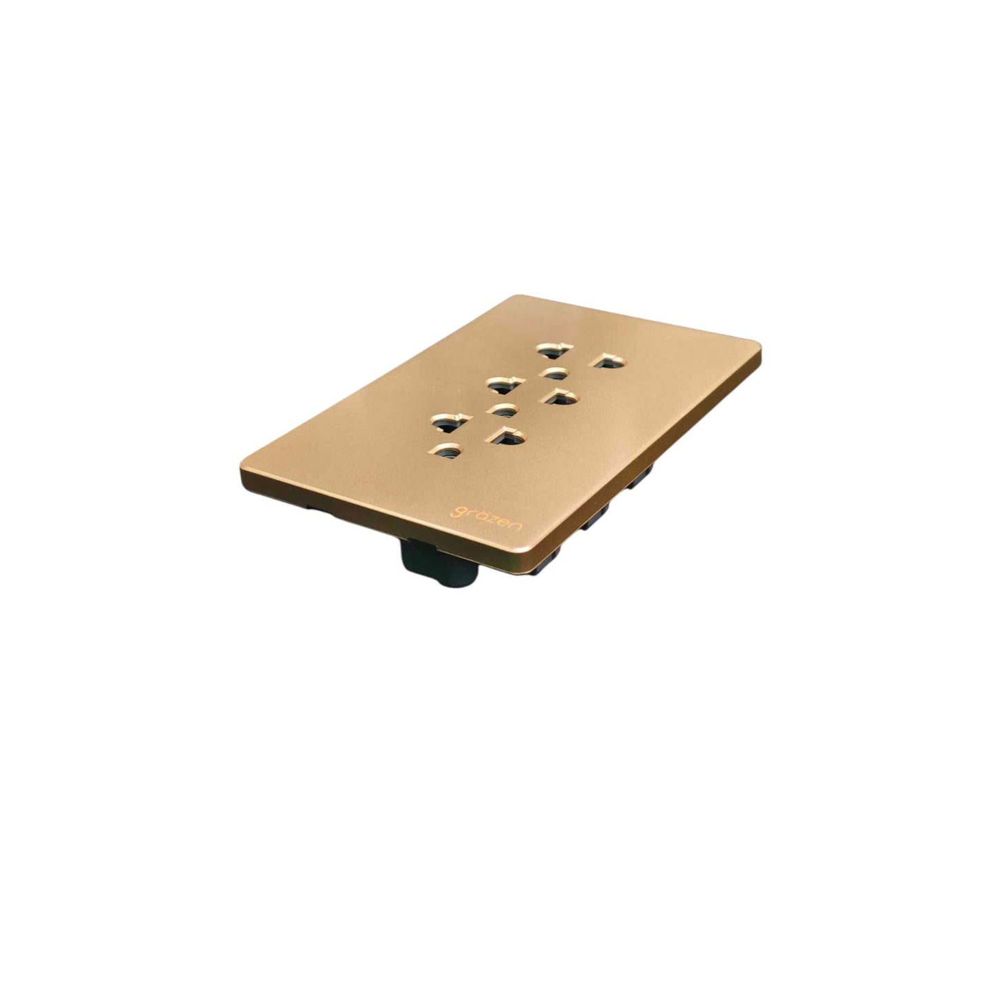 A square metallic wall plate in a warm gold finish, featuring multiple electrical outlets and a small brand logo near the bottom right, shown on a plain white background.