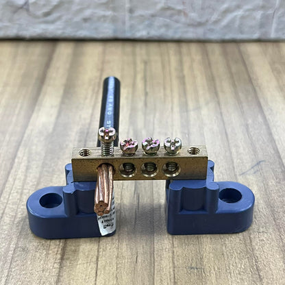 Grippes Electrical Grounding Bus Bars 4 Holes with screws and copper wire mounted on blue base
