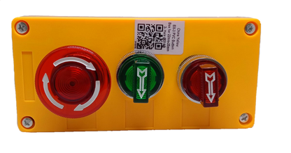 Auspicious illuminated emergency stop switch with red and green buttons mounted on a yellow panel