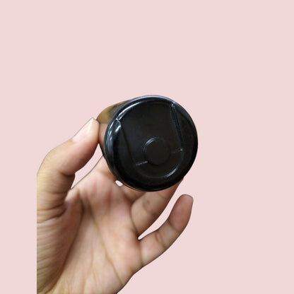 BMI 130-156 uf 110V AC start capacitor held in hand with a black cylindrical design