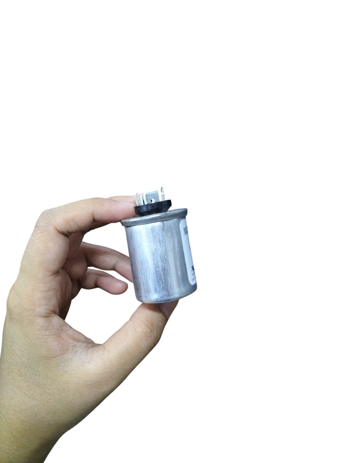 Hand holding a Mallory 3UF 440V oil-filled capacitor with silver casing for electrical applications