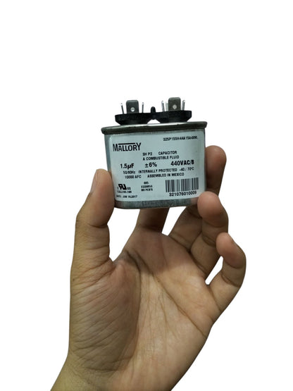 Mallory oil-filled running capacitor 440V AC held in hand, featuring a 1.5µF rating for reliable performance