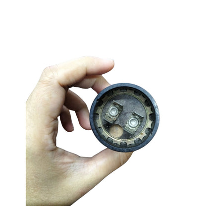 Mallory Starting Capacitor 72-86MFD held in hand showcasing its round design and connection points
