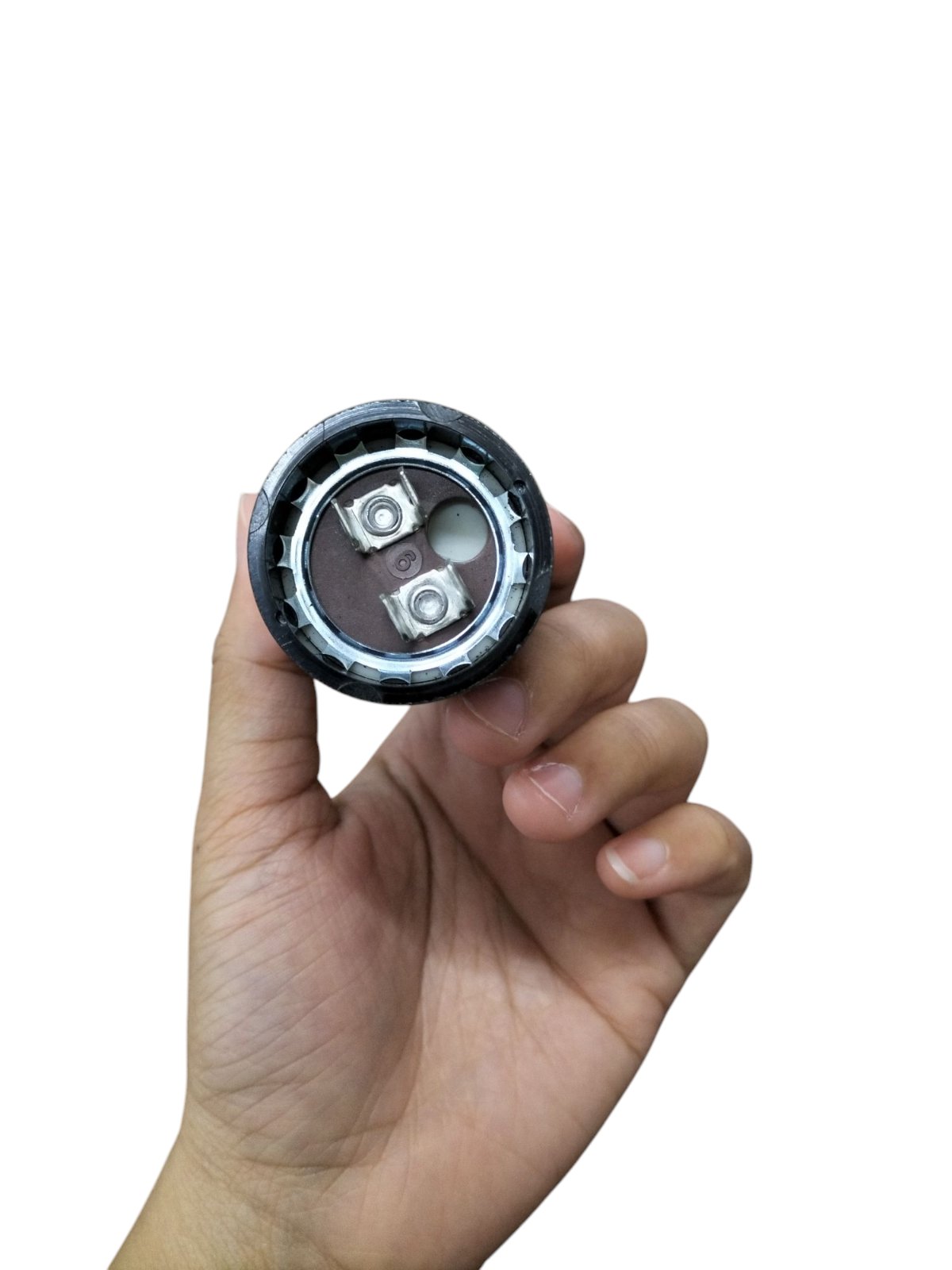 Mallory Starting Capacitor 88 to 106UF 330V held in hand showcasing its compact design